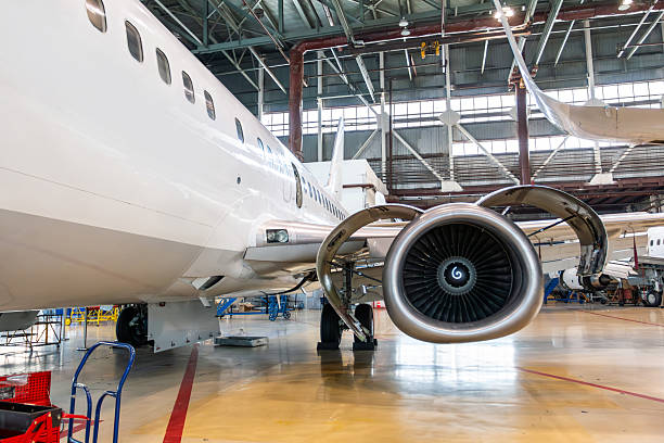 istock White passenger plane in the aircraft hangar. Airplane under maintenance 2253284546
