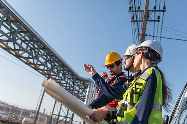 istock Engineers Reviewing Construction Plans at Industrial Gas Storage Facility, Industrial engineer inspecting petrochemical facility construction blueprint at gas storage plant site. 2253285086