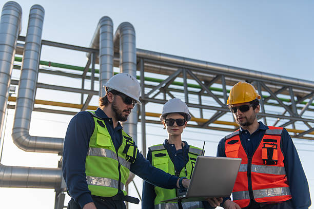 istock Industrial engineers collaborating on technical project at refinery plant, project management and modern construction technology, Oil and Gas Petrochemical industry. 2253285148