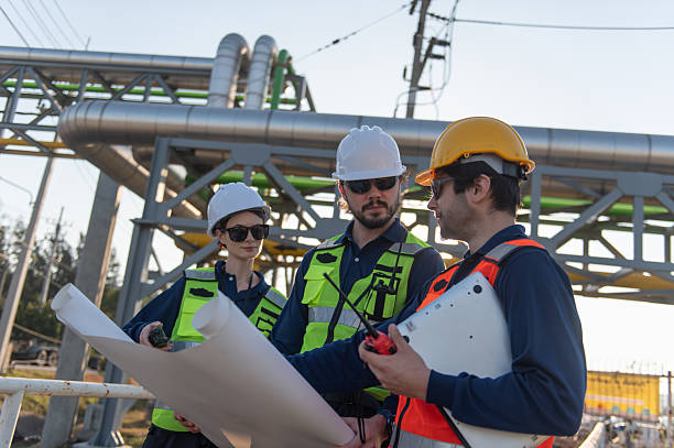 istock Engineers Reviewing Construction Plans at Industrial Gas Storage Facility, Industrial engineer inspecting petrochemical facility construction blueprint at gas storage plant site. 2253285190