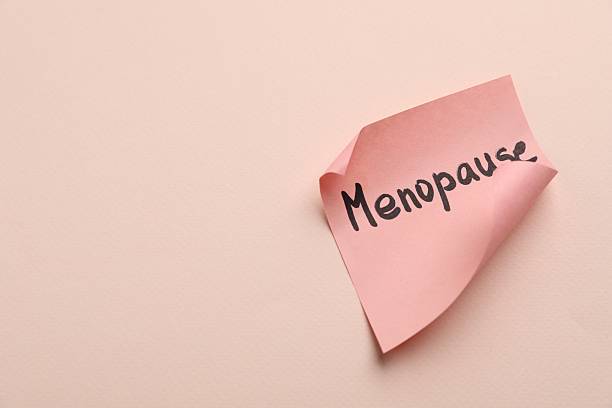 istock Paper note with word Menopause on beige background, closeup. Space for text 2253288570