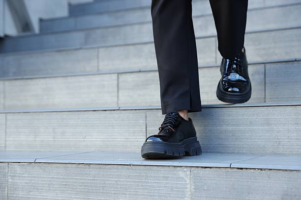 Woman walking down stairs outdoors, closeup view