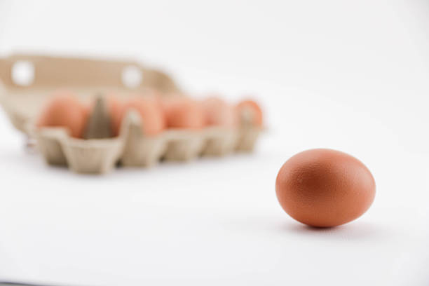 A Close-Up View Of Brown Eggs Arranged In A Recycled Cardboard Carton On A White Background, Showcasing Natural Texture And Packaging For Food And Grocery Themes.