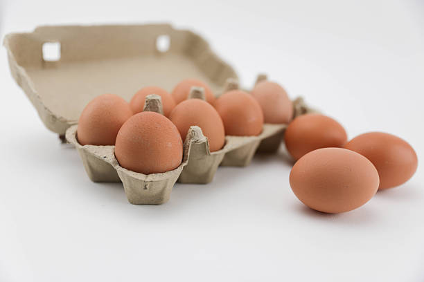 A Close-Up View Of Brown Eggs Arranged In A Recycled Cardboard Carton On A White Background, Showcasing Natural Texture And Packaging For Food And Grocery Themes.