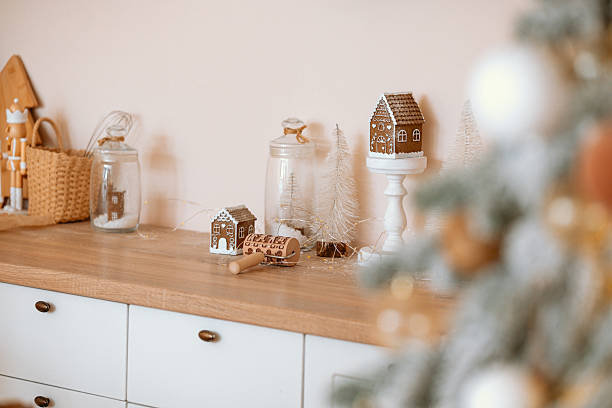 istock Gingerbread houses and festive decor on kitchen counter with blurred Christmas tree 2253293442