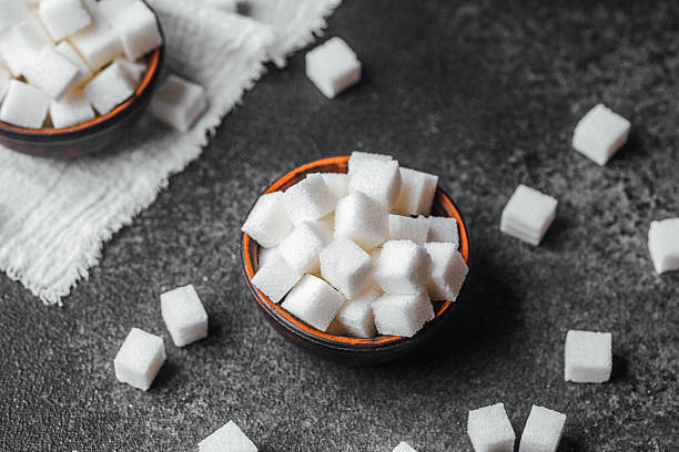 istock White sugar cubes arranged in small bowls on a dark textured background 2253293527
