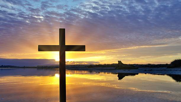 istock Dark Christian Cross Sunrise 2253293909