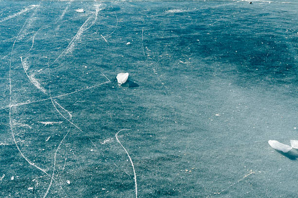 The picture was taken at Riddarfjarden in the middle of Stockholm, Sweden. Light ice-colored floes against a darker shade of the cold water