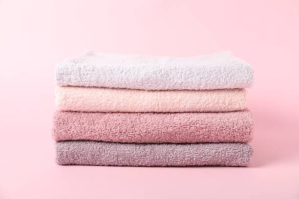 istock Stack of fresh terry towels on pink background 2253295210