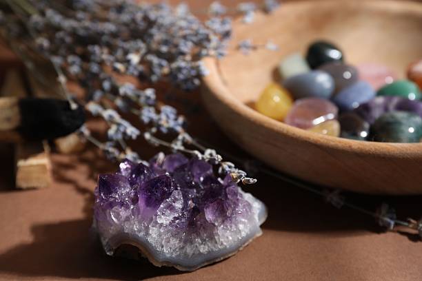 istock Different beautiful gemstones and lavender flowers on brown background, selective focus 2253295703