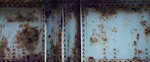 istock Steel rivets texture for infrastructure. Distressed metal for hazard warnings. Oxidized metal for infrastructure visuals. Old metal surface for renovation design. Checker plate rust for heavy industry. 2253296881