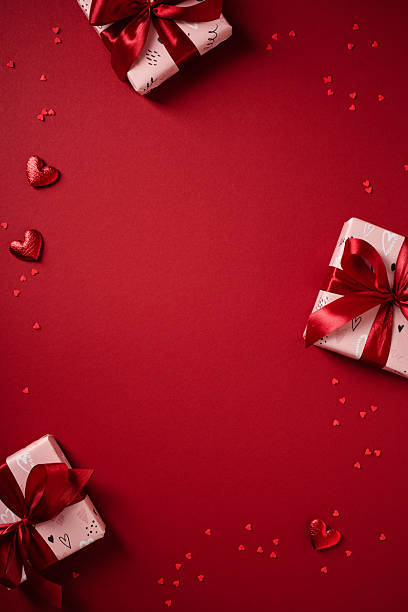 istock Vertical red Valentine's Day background with gifts in corners and central copy space. 2253296989