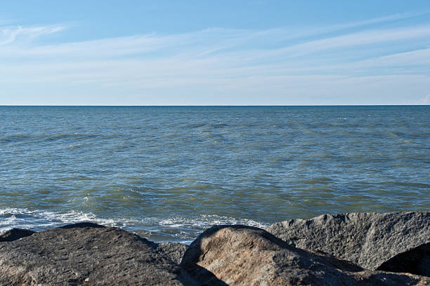 Rocky Black Sea Shore under Blue Sky with Clouds. Black Sea Horizon: Rocks, Waves and Vast Blue Sky