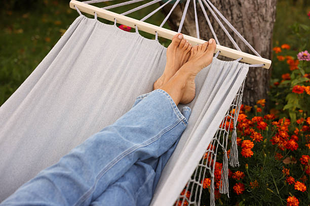 Senior woman resting in hammock outdoors, closeup