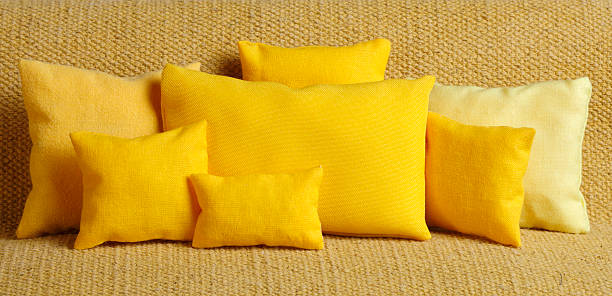Lot of yellow  cushions  on sofa