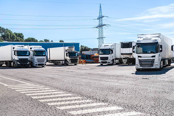 istock Commercial trucks parked at industrial distribution warehouse 2253302527