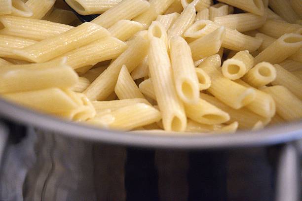 istock Cooked penne pasta in cooking pan, close-up 2253302815