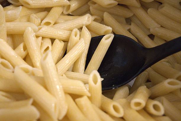 istock Cooked penne pasta in cooking pan, close-up 2253302820