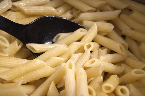 istock Cooked penne pasta in cooking pan, close-up 2253302830