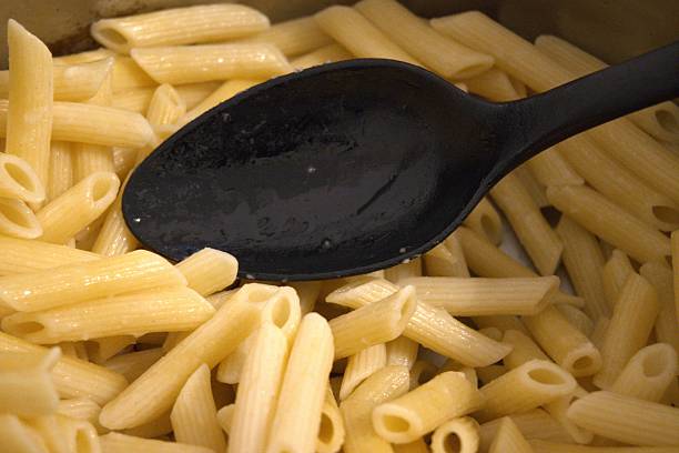 istock Cooked penne pasta in cooking pan, close-up 2253302831