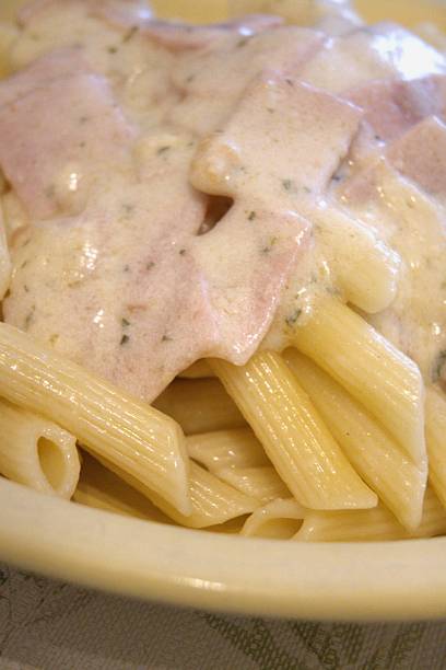 istock Cooked penne pasta with carbonara sauce on plate 2253303036