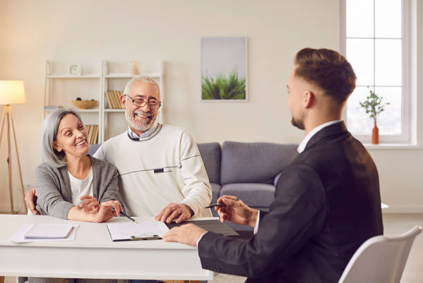 istock Agent Advising Senior Couple During Home Meeting 2253303347