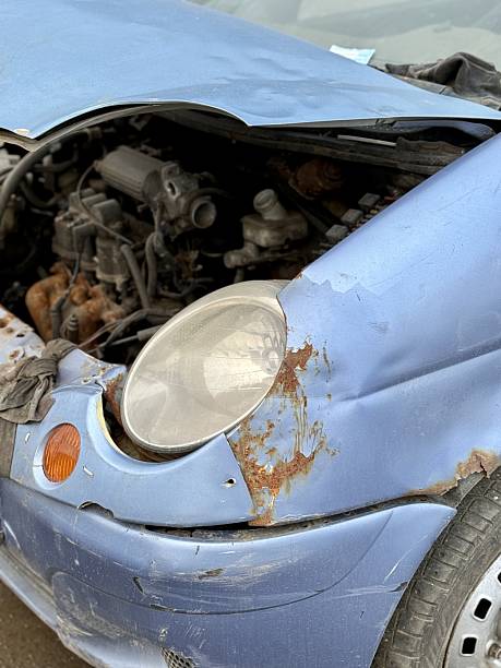 istock Blue Hatchback Collision Evaluation, Evaluation Of Blue Vehicle With Broken Parts After Crash, Assessment Of Accident Involving Blue Hatchback With Damaged Components On Slick Pavement 2253306474