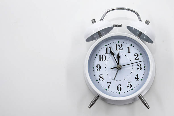 istock White alarm clock showing time isolated on light background for schedule planning concept 2253307123