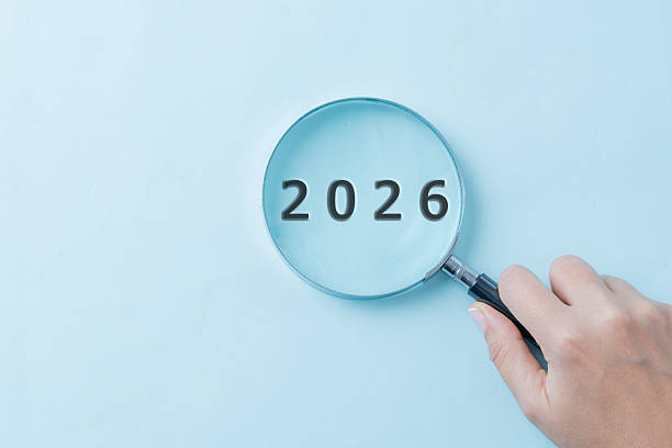 istock 2026 in Focus with Magnifying Glass on Blue Background, Future Concept 2253307336