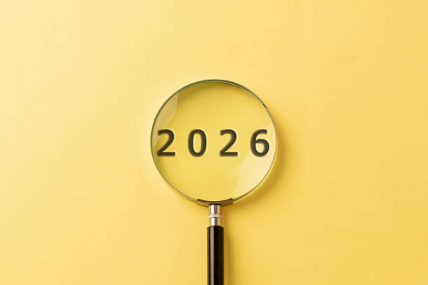 istock 2026 in Focus with Magnifying Glass on Yellow Background, Future Concept 2253307344