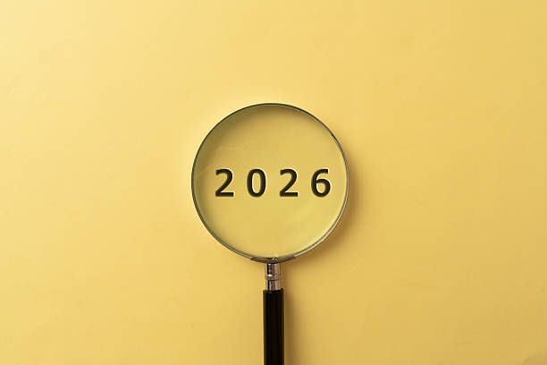 istock 2026 in Focus with Magnifying Glass on Yellow Background, Future Concept 2253307383