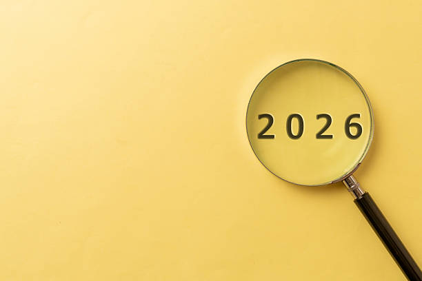istock 2026 in Focus with Magnifying Glass on Yellow Background, Future Concept 2253307384