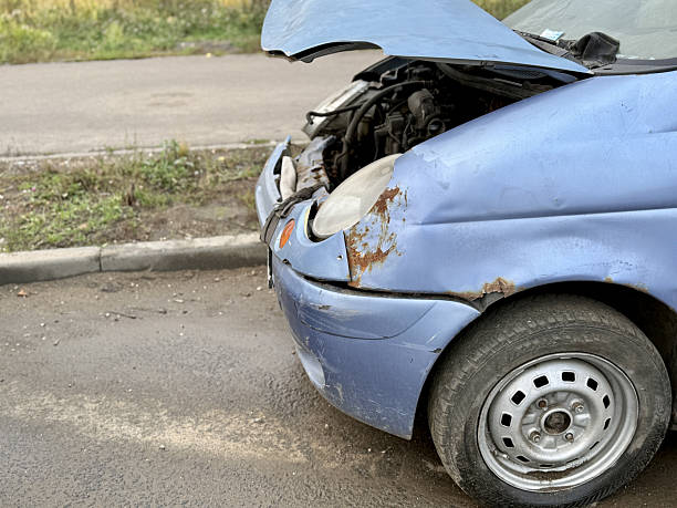 istock Blue Hatchback Collision Evaluation, Evaluation Of Blue Vehicle With Broken Parts After Crash, Assessment Of Accident Involving Blue Hatchback With Damaged Components On Slick Pavement 2253308594