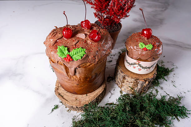 Panettone with melted chocolate frosting and cherries.