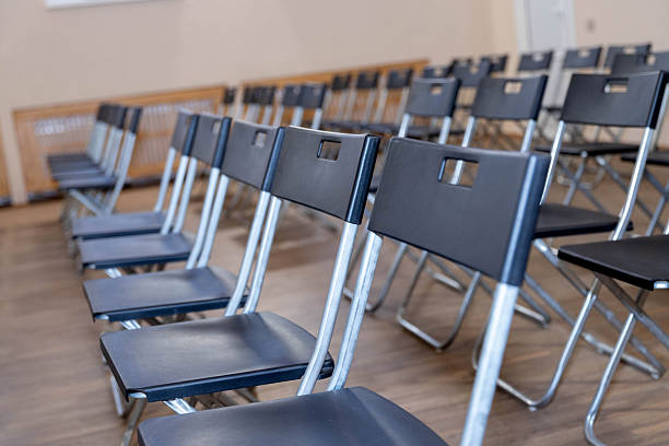 istock folding black chairs stand in a row on a white wooden floor outside 2253310811