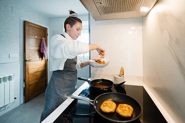 istock Woman cooking healthy meal in modern kitchen 2253312191