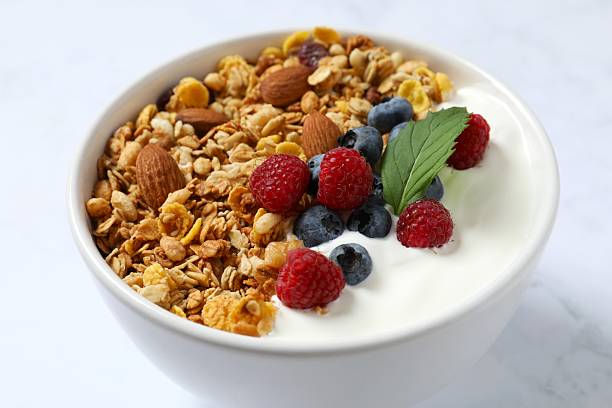 istock Delicious granola with berries and yogurt on a light background 2253312379