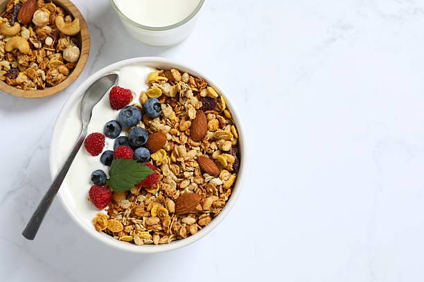 istock Delicious granola with berries and yogurt on a light background 2253312380