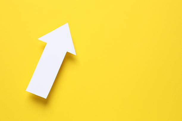 istock Paper arrow on color background, top view 2253312601