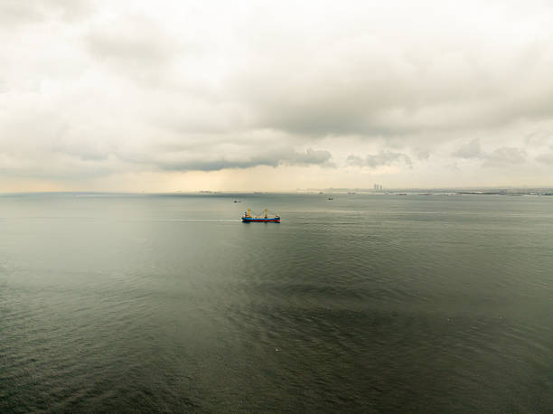 A bulk carrier loaded with grains sailing from the open sea towards