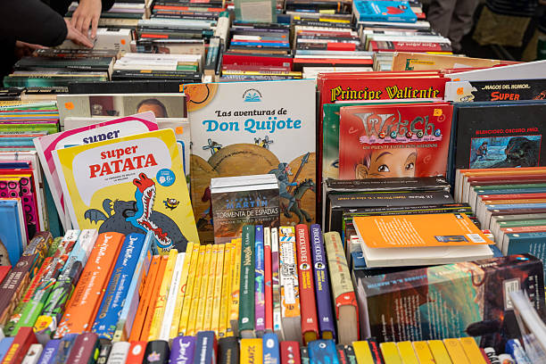Madrid, spain; 11 15 2025 customer browsing a wide selection of used books at a popular madrid street market