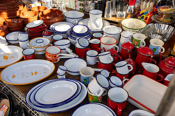 Madrid, spain; 11 15 2025 colorful enamelware plates, mugs, and pitchers displayed at a stall in an outdoor market