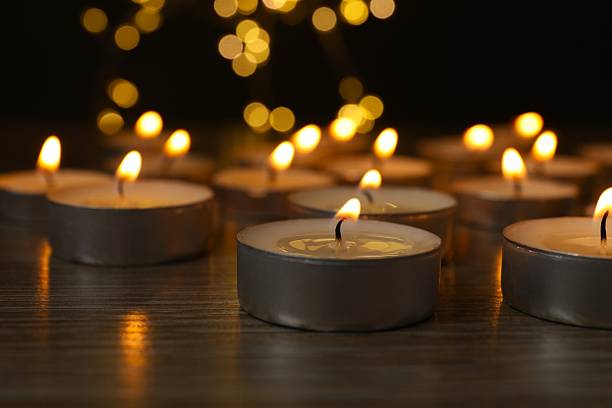 istock Burning candles in a dark space 2253313508