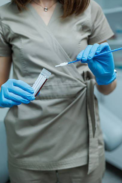 istock Smear for virus detection. Taking analysis with a smear. Nurse's hands close-up with a smear. 2253313693