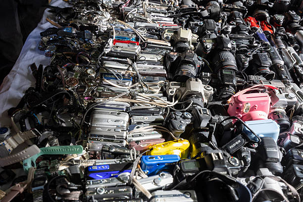 Madrid, spain; 11 15 2025 flea market stall selling a large collection of vintage cameras, electronics, and watches