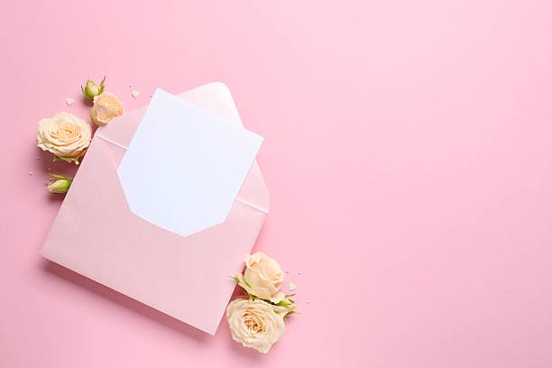 istock Beautiful composition with peony roses and paper envelope on pink background 2253313753