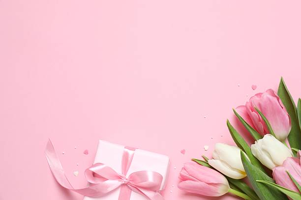 istock Beautiful fresh tulips and gift box on pink background 2253313775