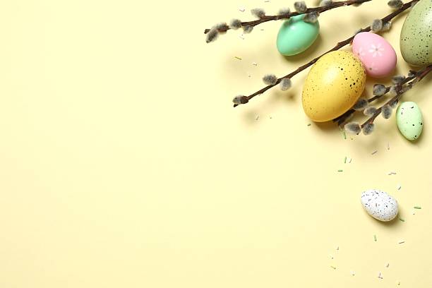 istock Colorful eggs, pussy willow branches, sweet sprinkles on a pastel beige background, space for text or advertising 2253313810