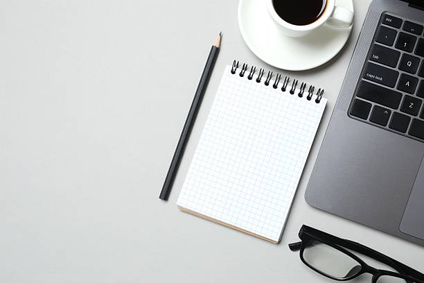 istock Workplace with laptop, coffee cup, pencil and notebook, top view 2253314261