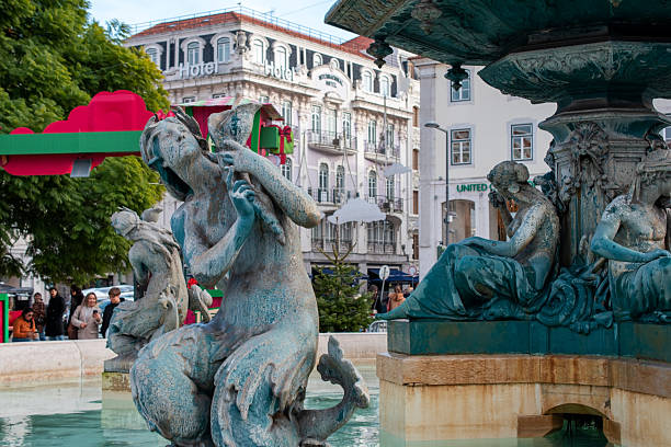 Ornate Fountain with Mythological Figures in a Bustling Lisbon Square, Lisbon, Portugal, November 29, 2025